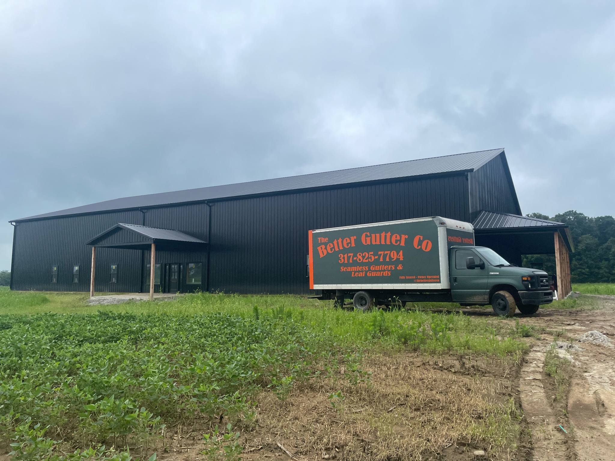 The Better Gutter Co truck at a completed gutter installation in Indianapolis