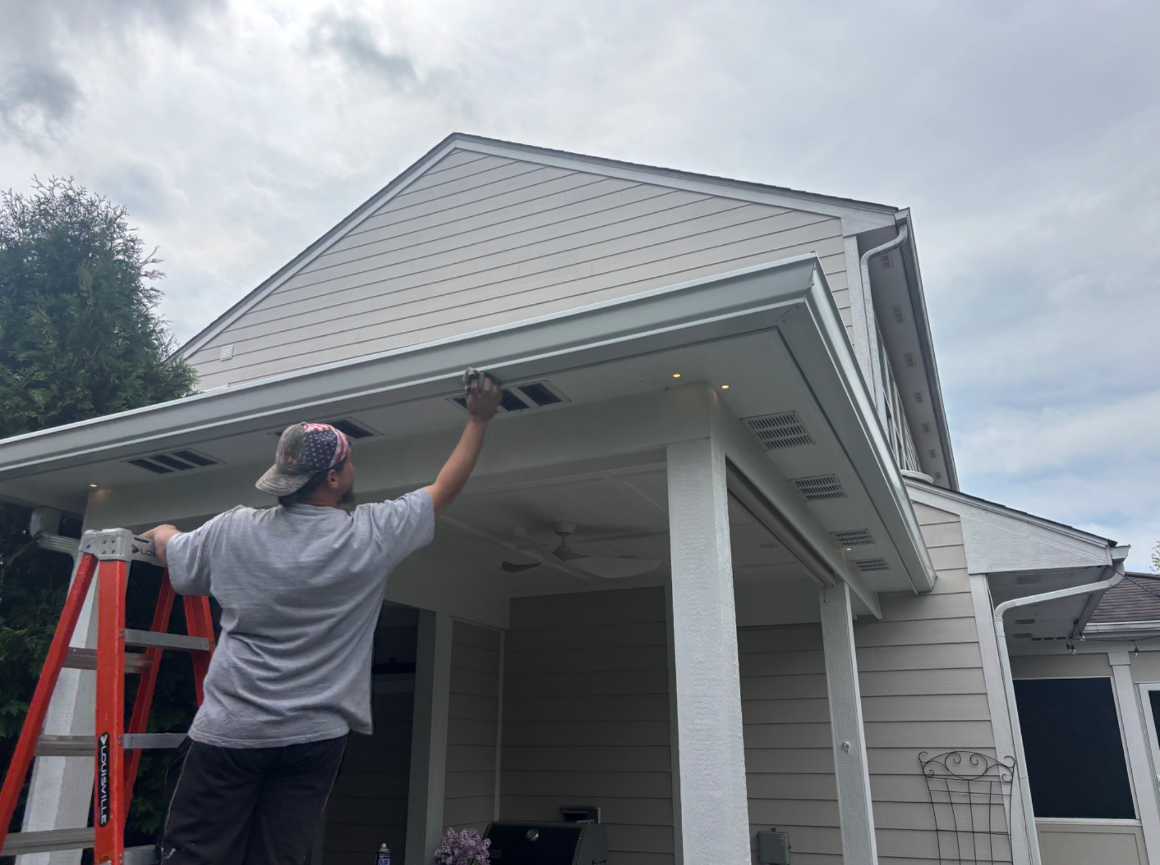 Steven wiping down a newly installed 6-inch seamless gutter in Indianapolis